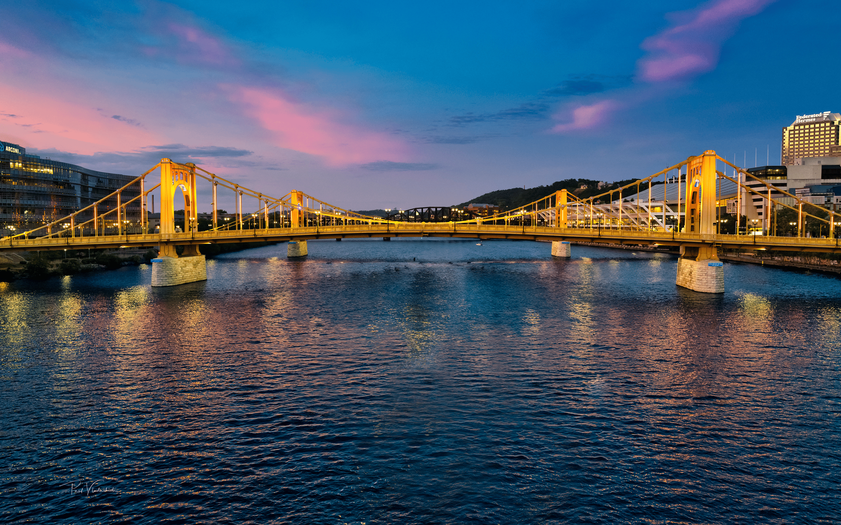 A beautiful picture of the river and several bridges in Pittsburgh.