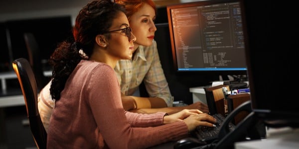 Two women at work computer station