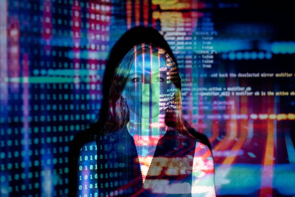 A stylistic photo of a woman with code overlaying her face.